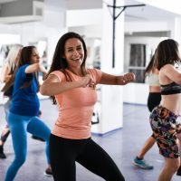 Female Smiling During Zumba Dance Class Moves